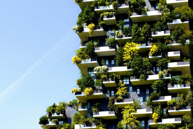 High-rise building with planted terraces and greenery growing on its facade